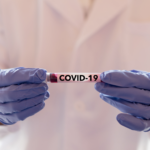 medical worker holding covid 19 vial